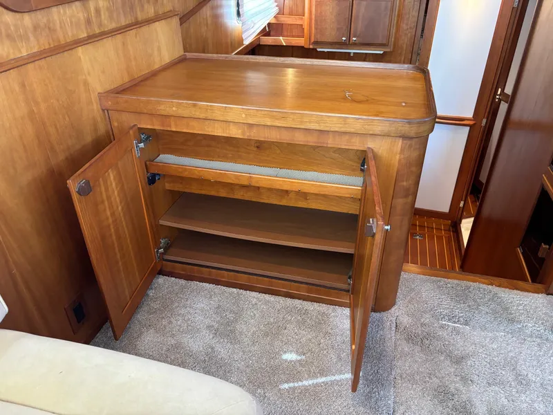 Slide: The Image of 2004 Sabreline 36 Sedan interior, wooden cabinet with open doors and shelves. - 38
