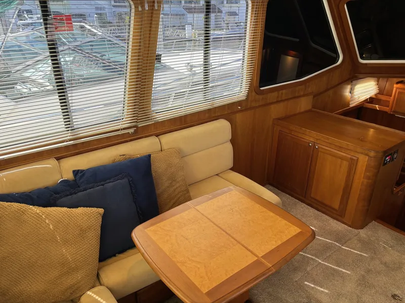 Slide: The Image of Interior of 2004 Sabreline 36 Sedan with beige seating and wooden table. - 41