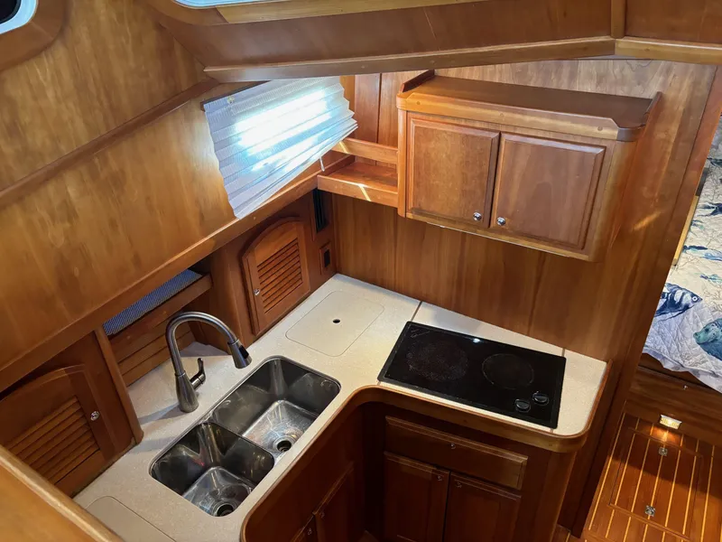 Slide: The Image of 2004 Sabreline 36 Sedan kitchen with wooden cabinetry and dual sink. - 43