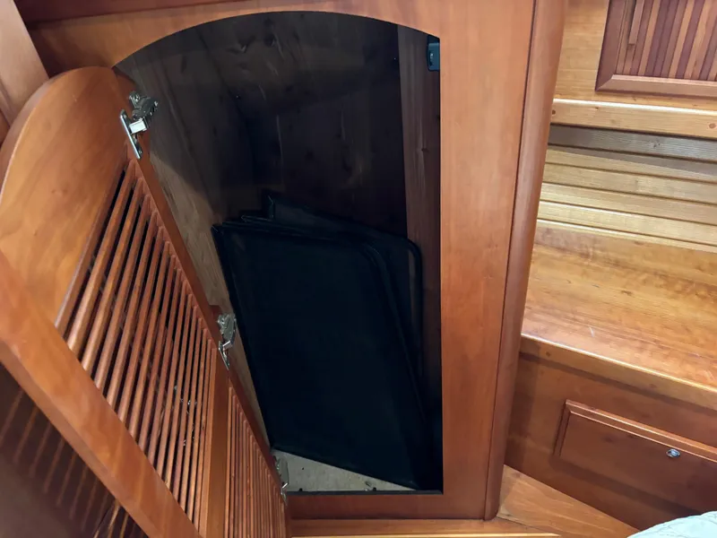 Slide: The Image of Open wooden cabinet in 2004 Sabreline 36 Sedan boat interior. - 48