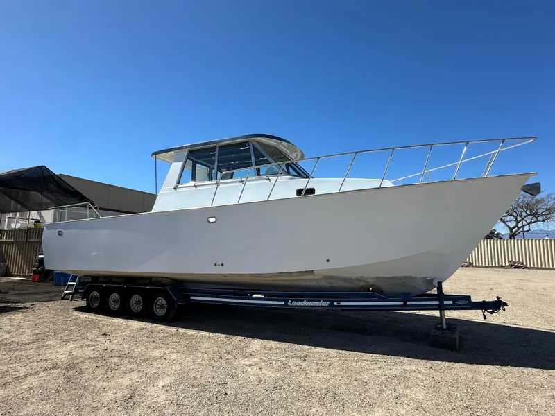 The Image of 1992 Custom Hueneme Boat Works on trailer in outdoor storage. - 0