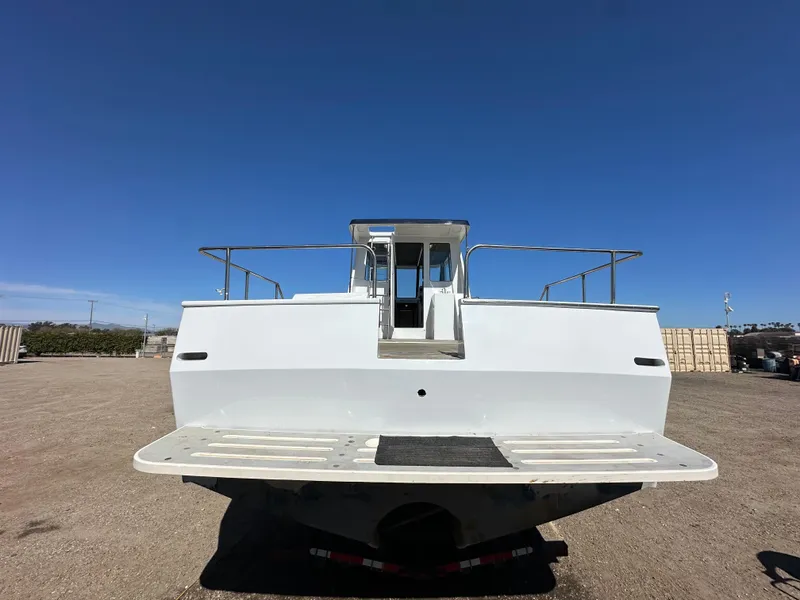 Slide: The Image of Custom 1992 Hueneme Boat Works vessel, rear view, docked on land under clear blue sky. - 14