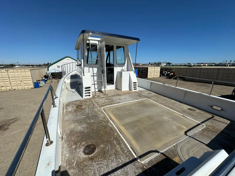 Slide: The Image of 1992 Custom Hueneme Boat Works vessel in a storage yard. - 16