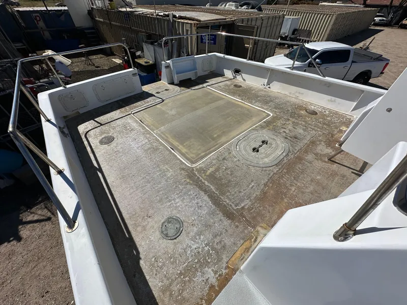 Slide: The Image of 1992 Custom Hueneme Boat Works deck, showing spacious layout and storage compartments. - 17