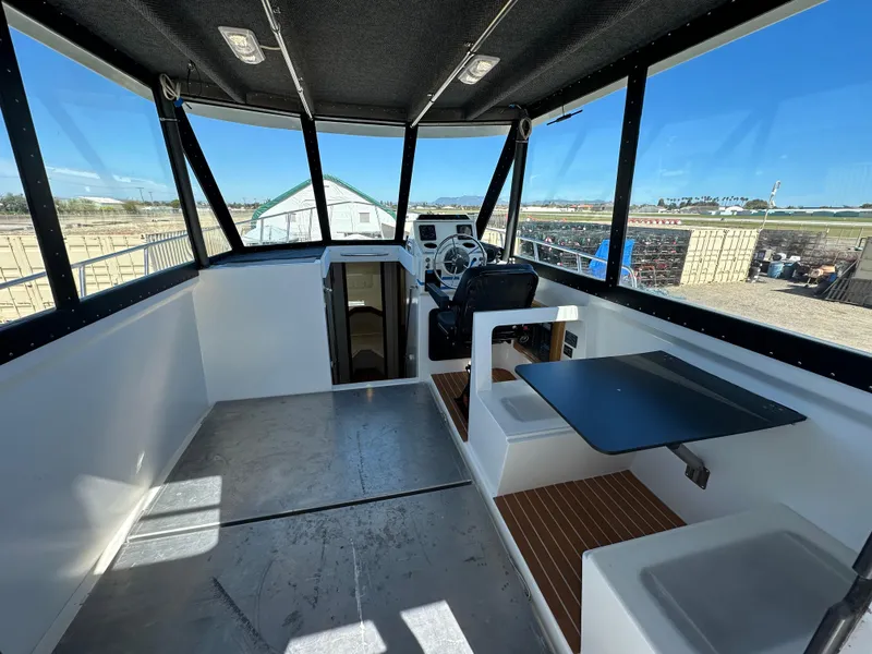 Slide: The Image of Interior of a 1992 Custom Hueneme Boat Works vessel with seating and navigation area. - 19