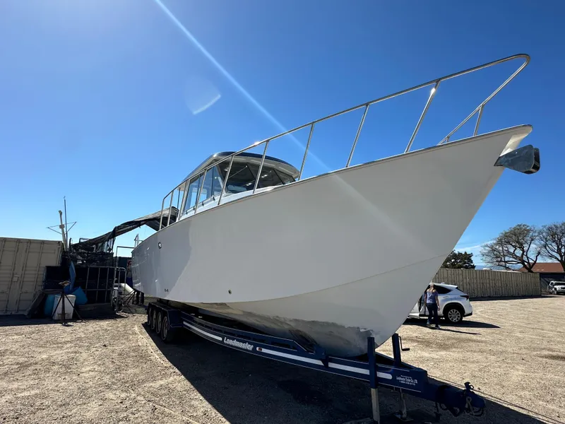 Slide: The Image of Custom 1992 Hueneme Boat Works vessel on trailer in a boatyard. - 2