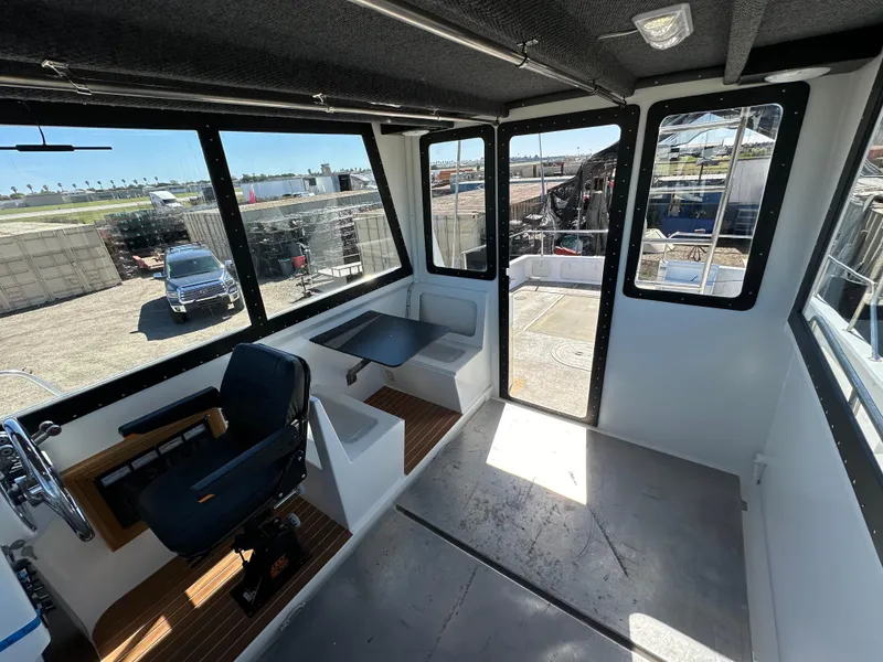 Slide: The Image of Interior of 1992 Custom Hueneme Boat Works vessel with seating and steering area. - 21
