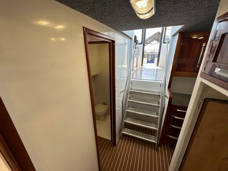 Slide: The Image of Interior of 1992 Custom Hueneme Boat Works with stairs, bathroom, and wooden cabinetry. - 28