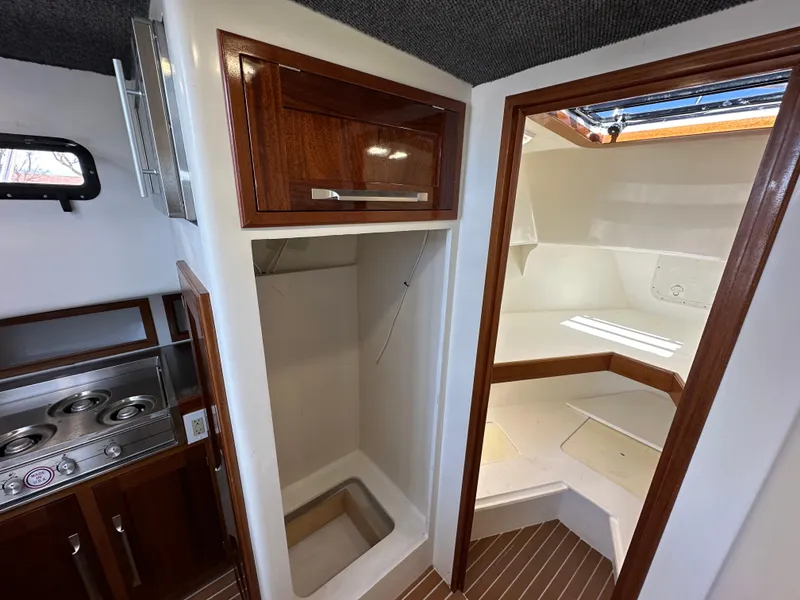 Slide: The Image of 1992 Custom Hueneme Boat Works interior with kitchenette and sleeping area. - 29