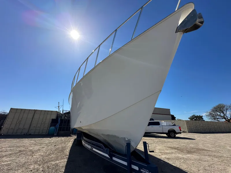 Slide: The Image of Custom 1992 Hueneme Boat Works vessel on trailer under bright sun. - 4
