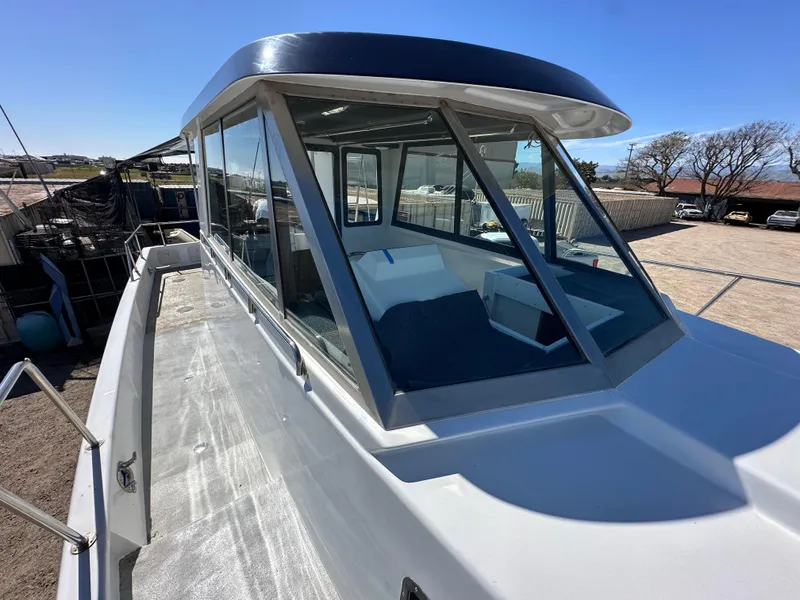 Slide: The Image of Custom 1992 Hueneme Boat Works vessel with enclosed cabin, docked on a sunny day. - 9
