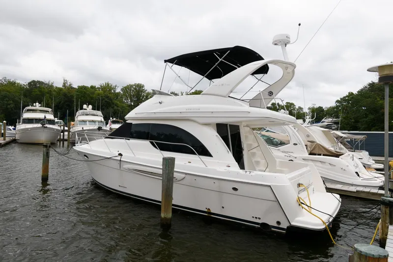 The Image of 2003 Meridian 381 Sedan yacht docked at marina, overcast sky. - 0