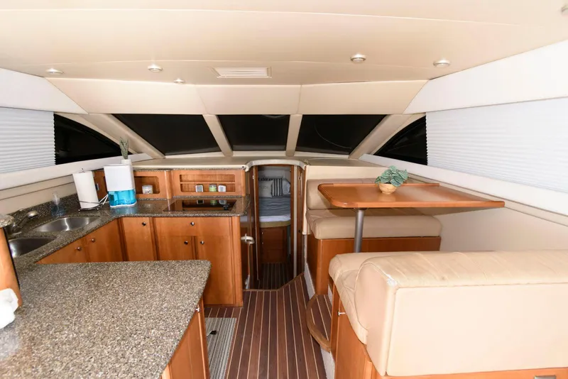 Slide: The Image of Interior of 2003 Meridian 381 Sedan yacht with kitchen and dining area. - 10