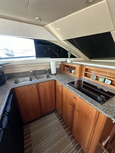 Slide: The Image of 2003 Meridian 381 Sedan kitchen with granite countertops and wooden cabinets. - 13
