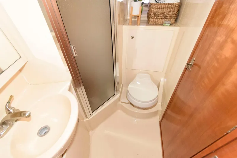 Slide: The Image of Compact bathroom in 2003 Meridian 381 Sedan yacht with shower, sink, and toilet. - 18