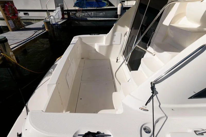 Slide: The Image of 2003 Meridian 381 Sedan boat deck, spacious and well-maintained, docked at marina. - 3