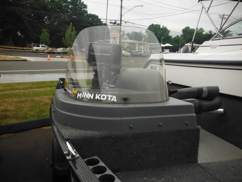 Slide: The Image of 2018 Lund 1625 Fury XL SS boat with Minn Kota motor, docked outdoors. - 16