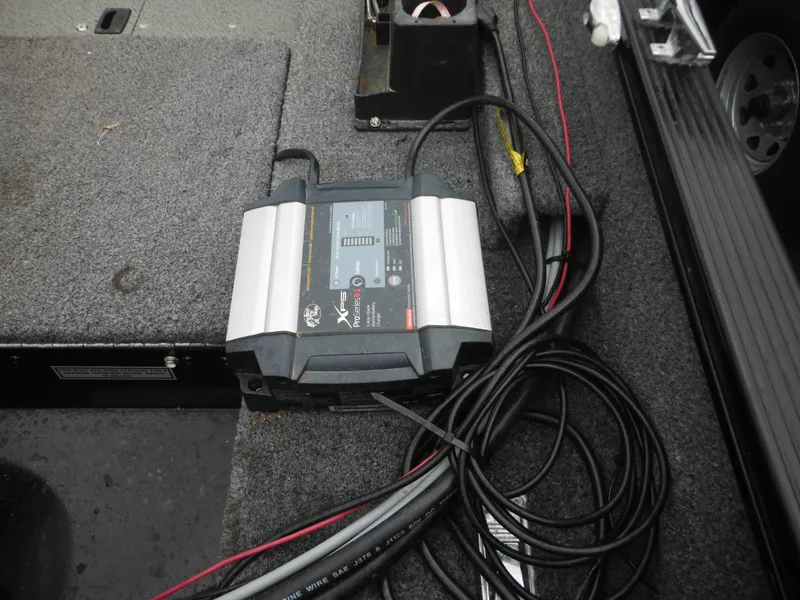 Slide: The Image of 2018 Lund 1625 Fury XL SS boat interior with battery charger and cables. - 19