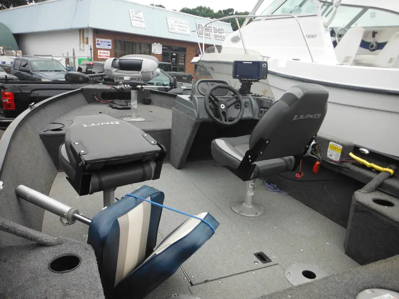 Slide: The Image of 2018 Lund 1625 Fury XL SS fishing boat interior with seats and steering console. - 22