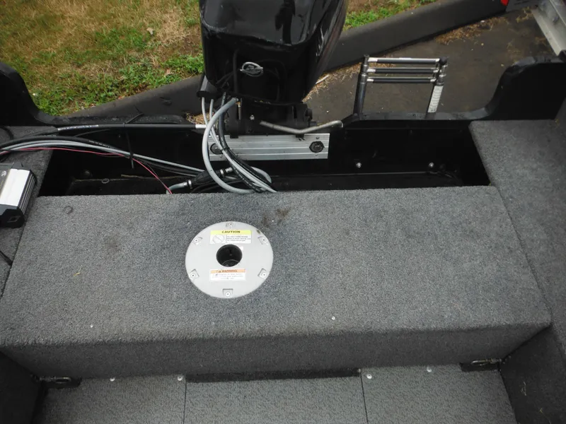 Slide: The Image of 2018 Lund 1625 Fury XL SS boat interior with motor and seating area. - 29