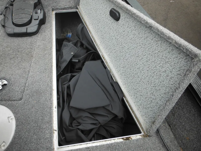 Slide: The Image of 2018 Lund 1625 Fury XL SS boat storage compartment with black cover. - 32