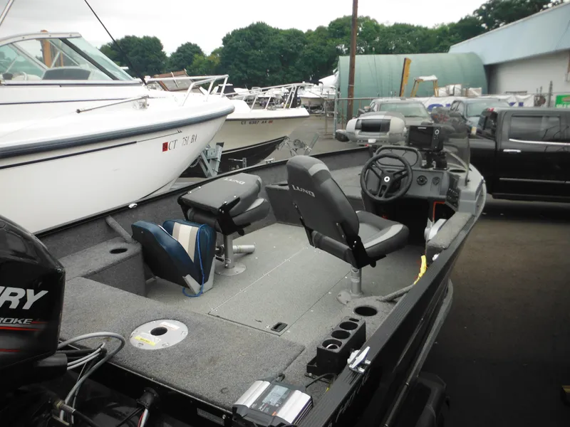 Slide: The Image of 2018 Lund 1625 Fury XL SS fishing boat with Mercury outboard motor in a marina. - 36