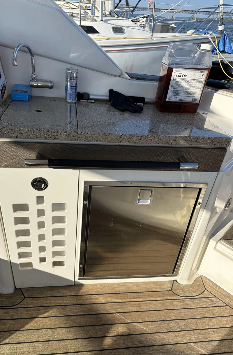 Slide: The Image of Outdoor kitchenette on 2014 Sea Ray 350 SLX boat with sink and mini fridge. - 12