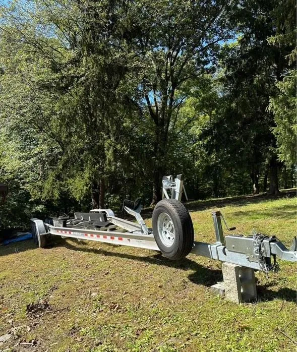 Slide: The Image of Trailer for 2014 Sea Ray 350 SLX boat in a wooded area. - 19