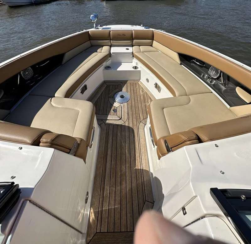 Slide: The Image of 2014 Sea Ray 350 SLX boat interior with tan seating and wooden deck. - 8