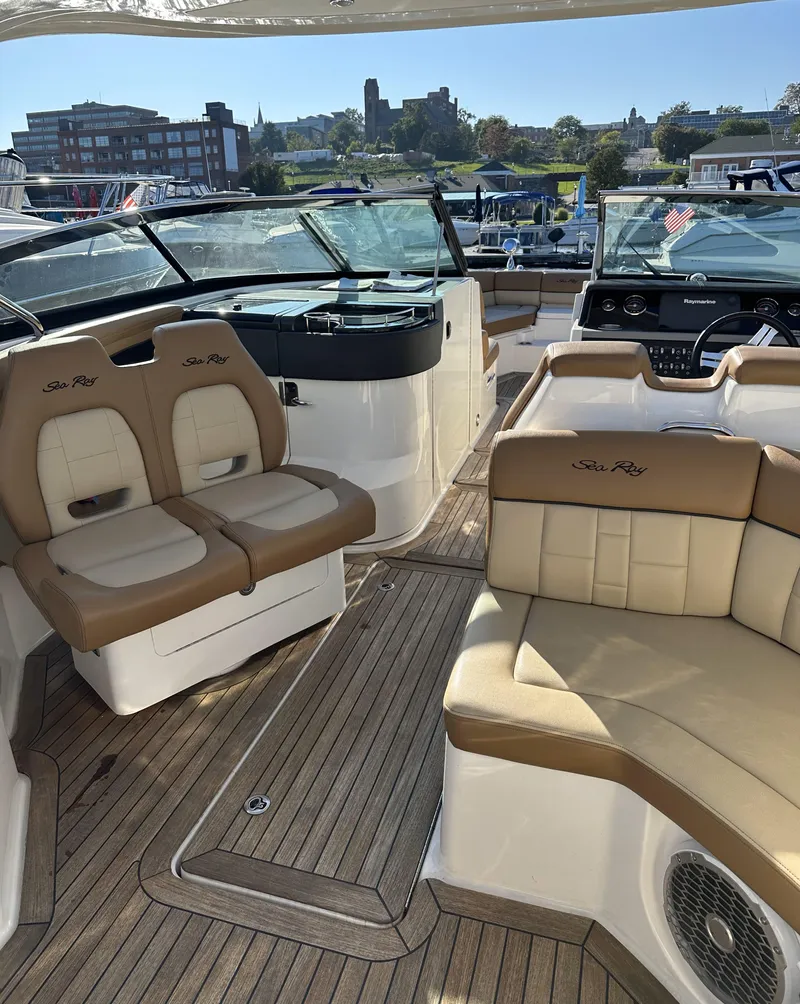 Slide: The Image of 2014 Sea Ray 350 SLX boat interior with tan seating and wood flooring. - 9