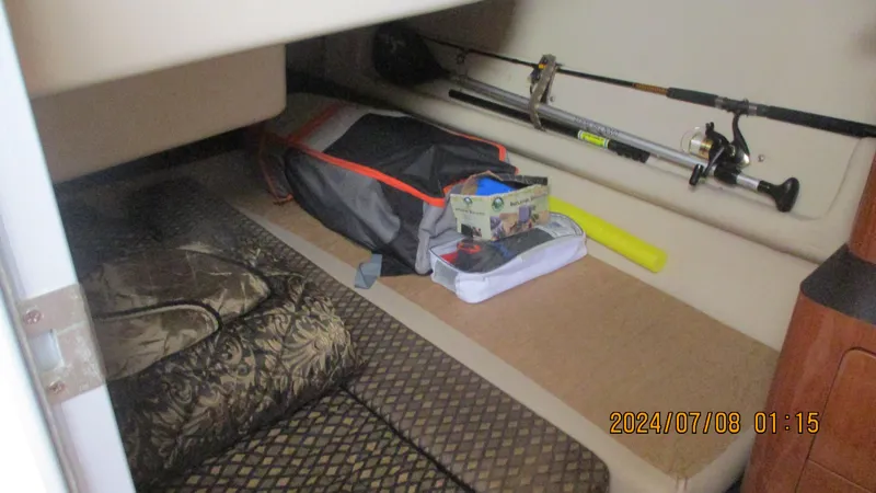 Slide: The Image of Interior storage area of a 2007 Regal 4080 Sportyacht with fishing gear and bags. - 34