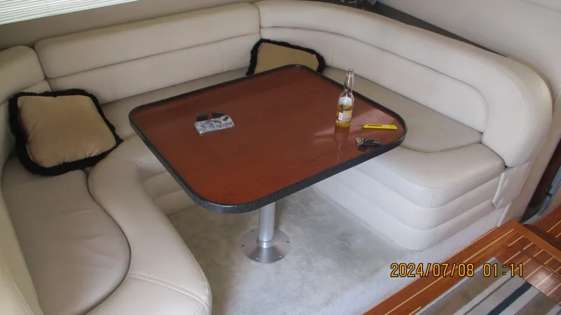 Slide: The Image of Interior of 2007 Regal 4080 Sportyacht with beige leather seating and wooden table. - 17