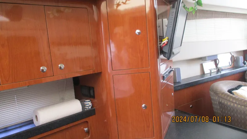 Slide: The Image of Interior of 2007 Regal 4080 Sportyacht with wooden cabinetry and modern amenities. - 26