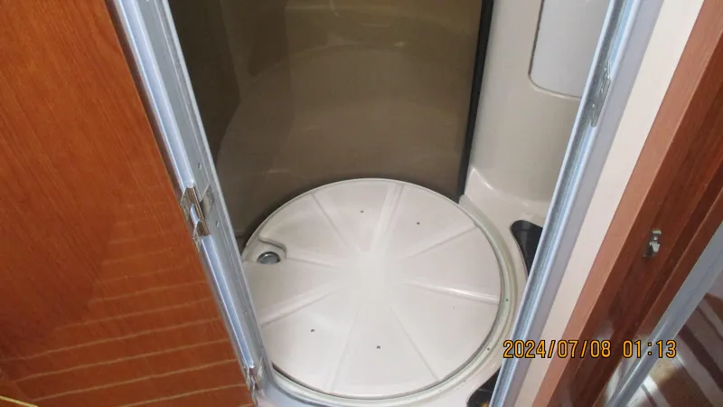 Slide: The Image of Shower area in 2007 Regal 4080 Sportyacht with wooden door and circular base. - 27