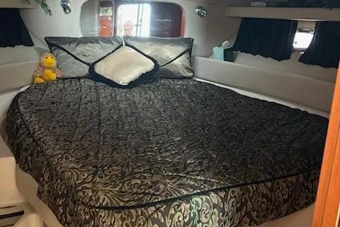 Slide: The Image of Luxurious bedroom in a 2007 Regal 4080 Sportyacht with elegant bedding. - 31