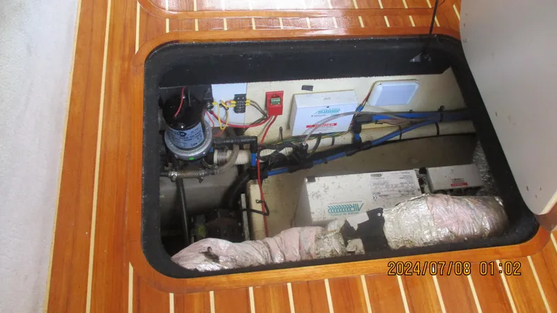 Slide: The Image of 2007 Regal 4080 Sportyacht engine compartment with visible wiring and components. - 16