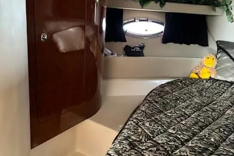 Slide: The Image of 2007 Regal 4080 Sportyacht interior cabin with bed and storage cabinet. - 30