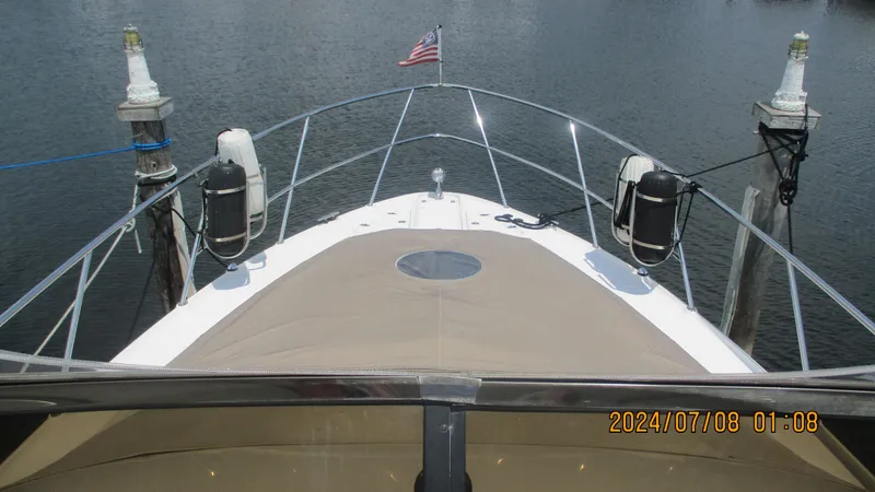 Slide: The Image of 2007 Regal 4080 Sportyacht docked, bow view with American flag. - 4