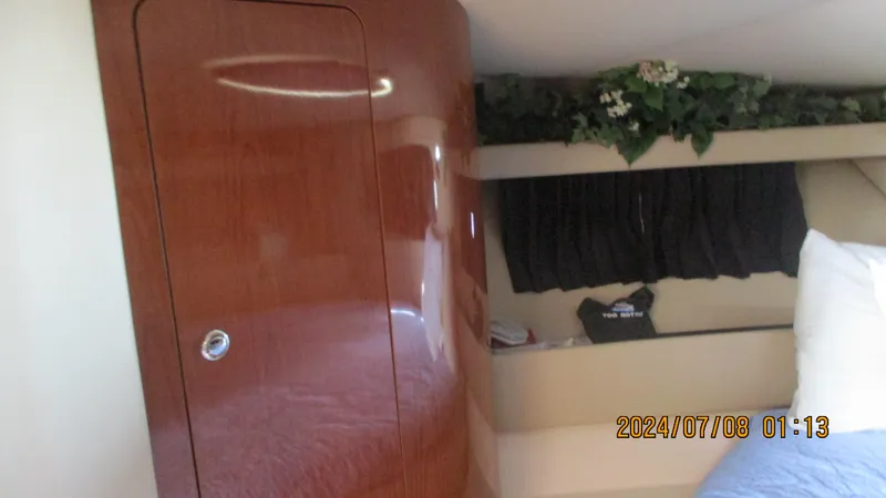Slide: The Image of Interior cabin of a 2007 Regal 4080 Sportyacht with wooden cabinetry and bed. - 29