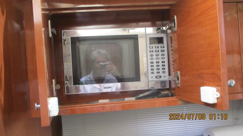Slide: The Image of Built-in microwave in the kitchen of a 2007 Regal 4080 Sportyacht. - 22
