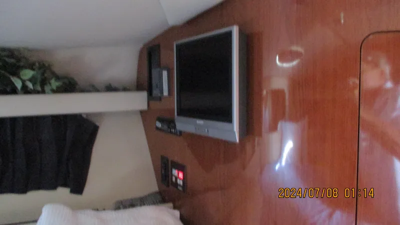 Slide: The Image of Interior cabin of a 2007 Regal 4080 Sportyacht with mounted TV and control panel. - 32