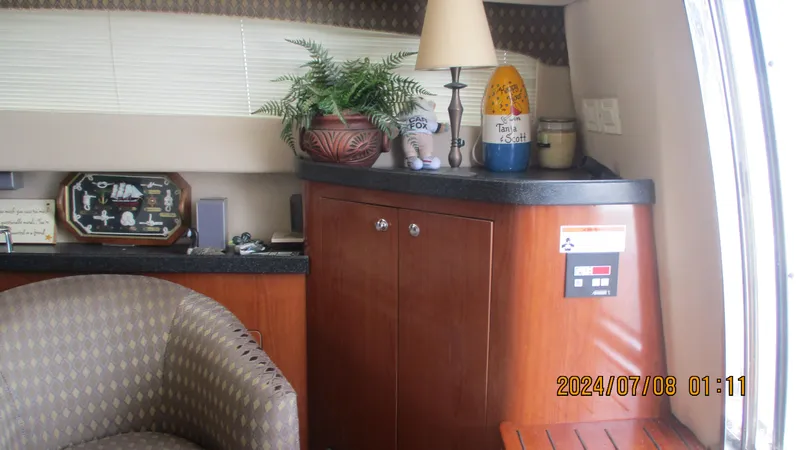Slide: The Image of Interior of 2007 Regal 4080 Sportyacht with wooden cabinetry and decorative items. - 23