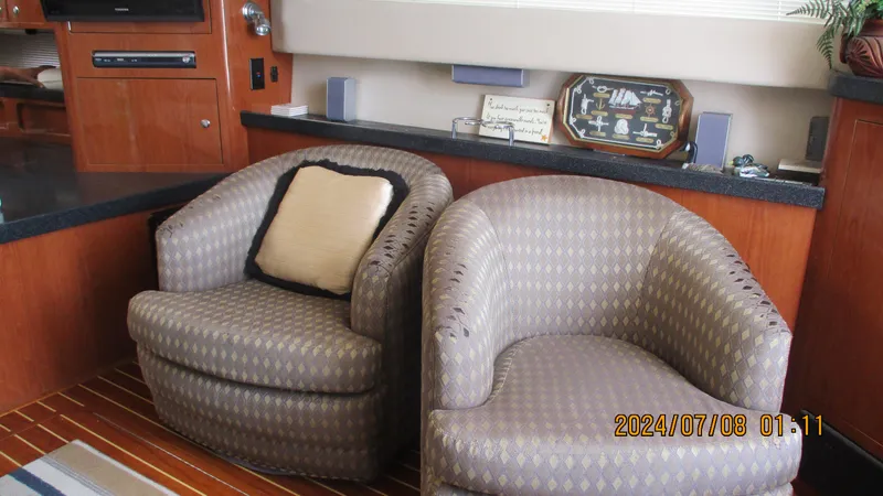 Slide: The Image of Interior of 2007 Regal 4080 Sportyacht with two patterned armchairs. - 18