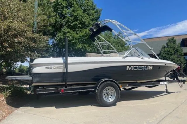 Slide: The Image of 2001 Moomba Mobius SK boat on a trailer in a driveway. - 0