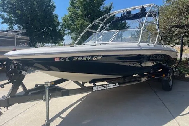 Slide: The Image of 2001 Moomba Mobius SK boat on a trailer in a driveway. - 3