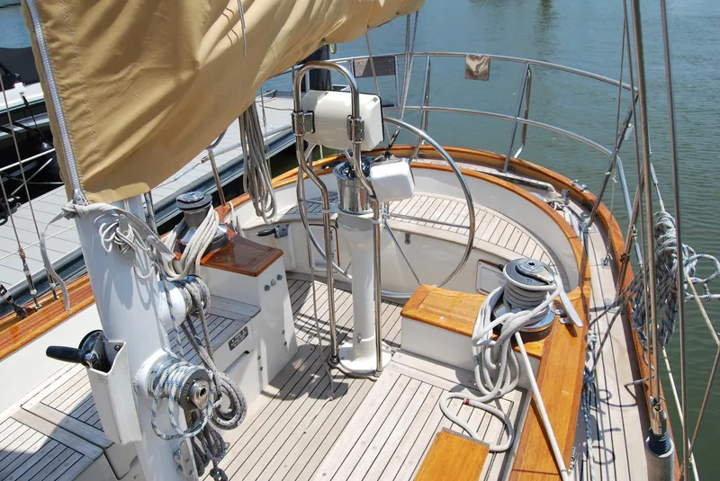 Slide: The Image of 1983 Cherubini 44 Ketch sailboat deck with wooden accents and rigging. - 2
