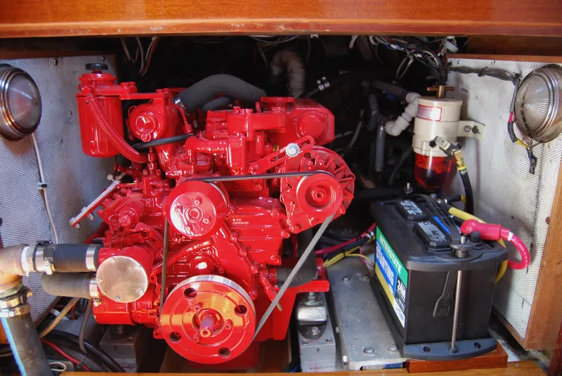 Slide: The Image of Red engine and battery compartment of a 1983 Cherubini 44 Ketch sailboat. - 5