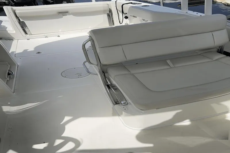 Slide: The Image of 2017 Boston Whaler 270 Vantage boat interior with white seating and spacious deck. - 13