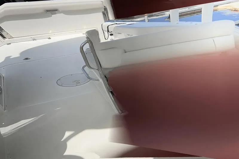 Slide: The Image of 2017 Boston Whaler 270 Vantage boat interior with white seating and deck. - 14