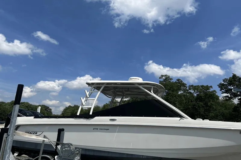 Slide: The Image of 2017 Boston Whaler 270 Vantage boat under a clear blue sky. - 2